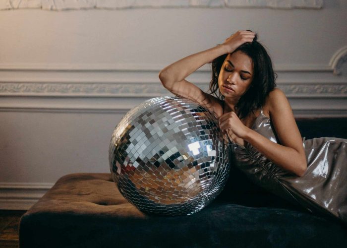 photo-of-woman-leaning-on-disco-ball-3402579b